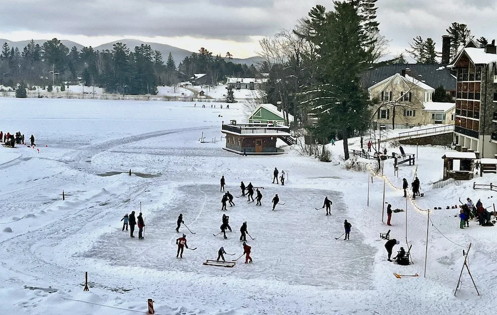 lake placid is a winter paradise with ice skating, snow and fun on the frozen lake.
