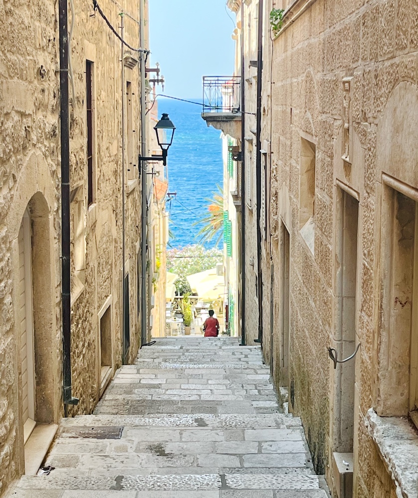 In korcula's old town, every long, slim alleyway leads to the blue adriatic sea.