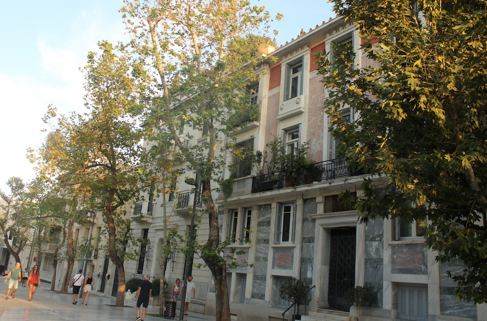 Dionysiou areopagitou is a wide pedestrian street in athens' plaka neighborhood, outside of the acropolis. It has stately townhouse and buskers.