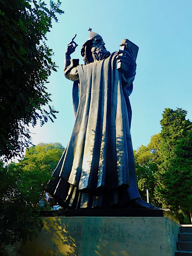 gregor of nin's statue in split depicts him as an imposing, wizard-like figure.