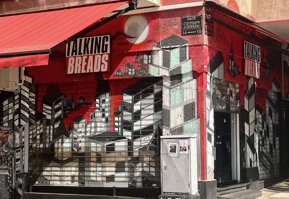 the red and black facade of talking breads in exarchia is reminiscent of a certain 80s band's album art.