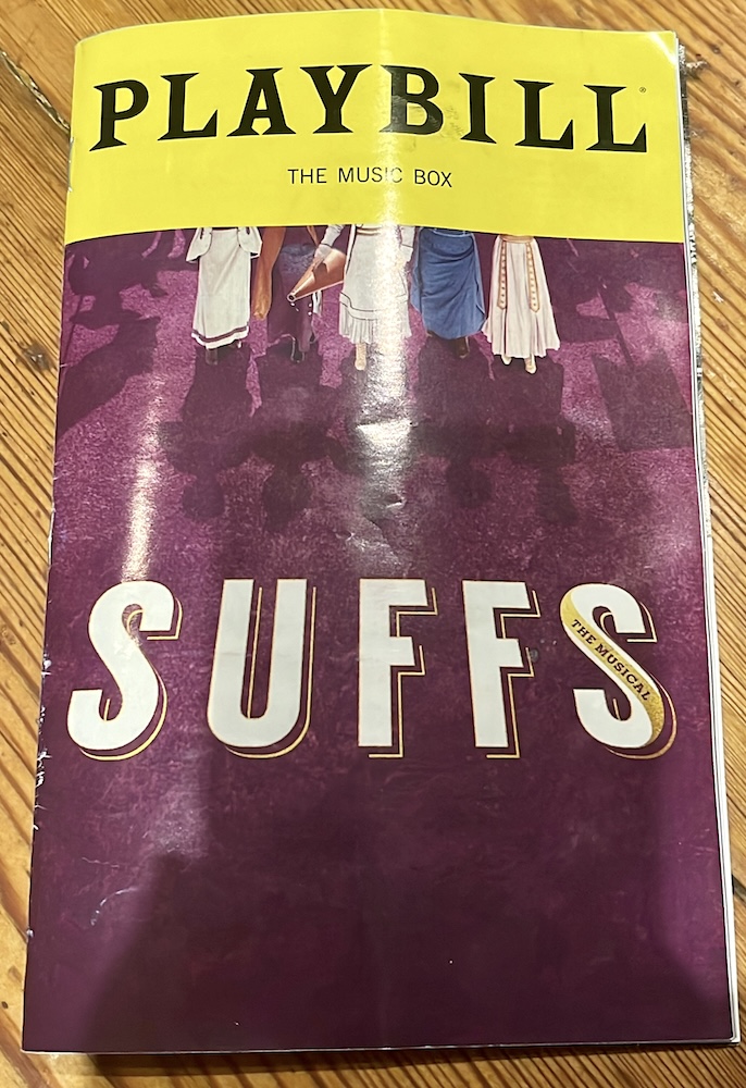 the playbill for the play suffs! showing women in early 20th centure clothes marching for their rights. 