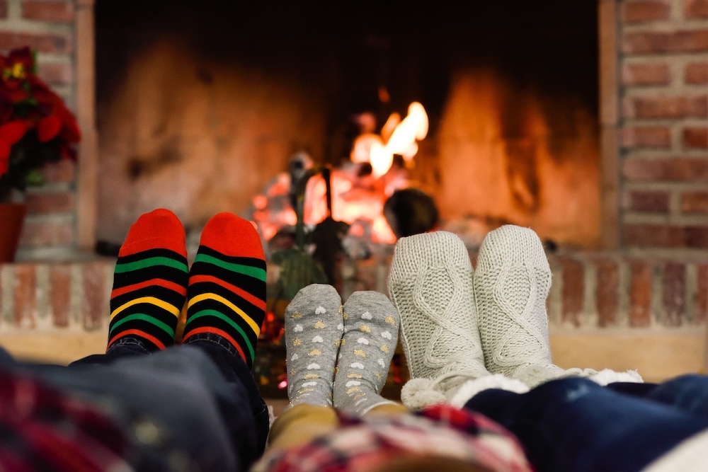 A packing list for a winter vacation should include comfortable clothes for chilling out by the fire together.