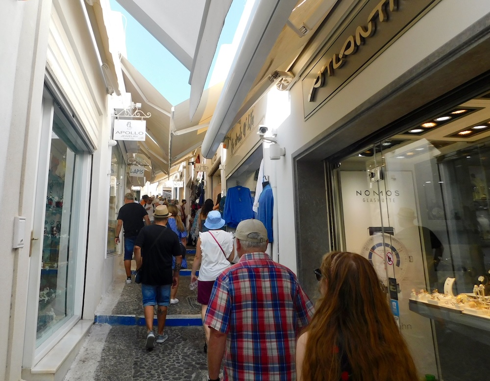 Crowds of cruise passengers make their way back to the cable cars at the end of their santorini port day