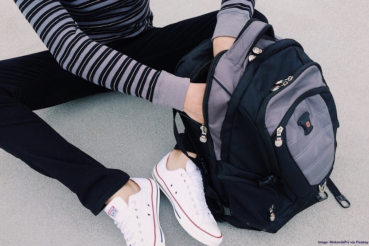 Print This Vital Carry-On Packing List For Adults & Kids: A teen packs her backpack with everything she'll need for a flight on vacation