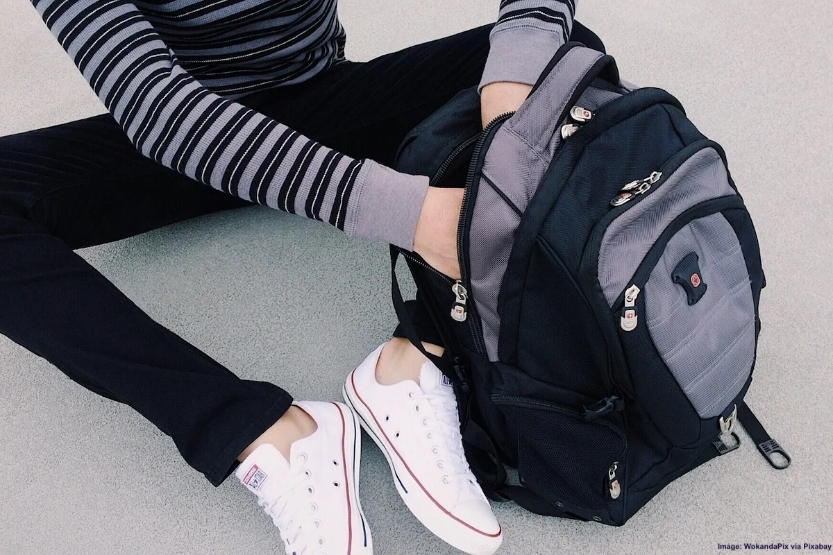 Print This Vital Carry-On Packing List For Adults & Kids: A teen packs her backpack with everything she'll need for a flight on vacation
