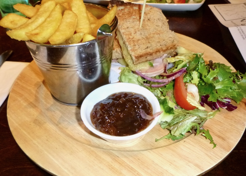 A pretty grilled-cheese sandwich with fruit chutney and a tin of fries a the albanach pun on the royal mile.