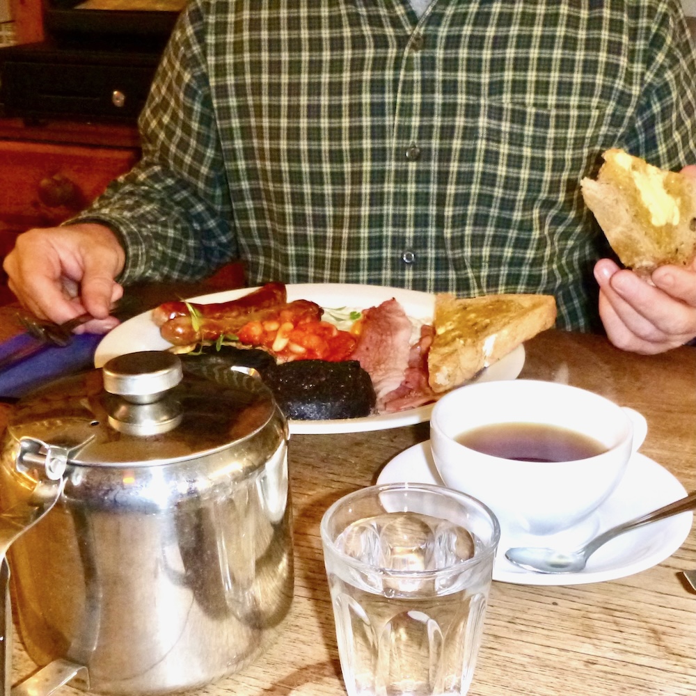 A man digs into the made-from-scratch full scottish breakfast at edinburgh larder.