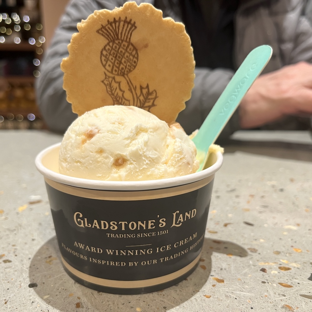 Scottish tablet ice cream comes with a wafer cookie with a scottish thistle at gladstone's land in edinburgh.