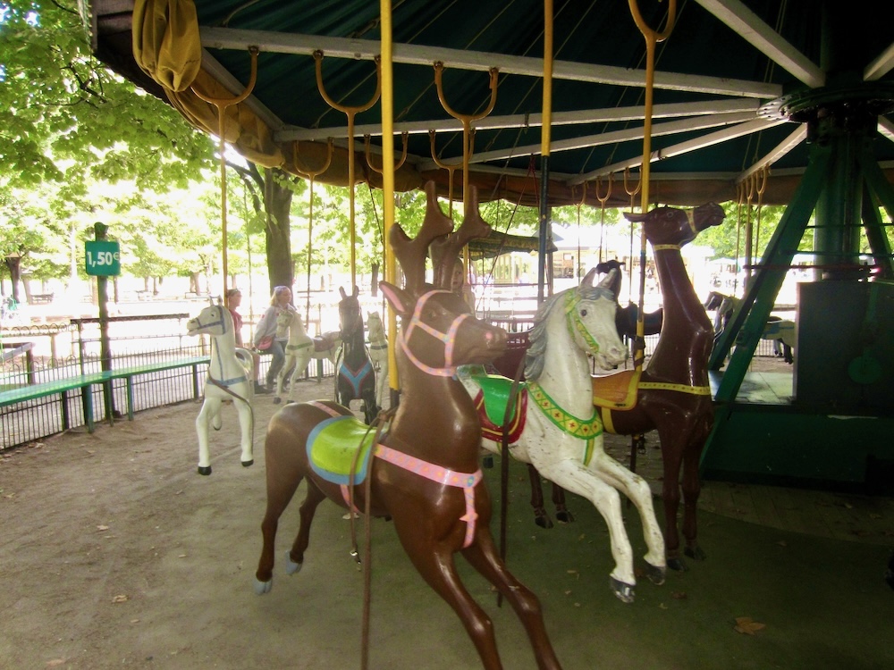 Nearly every park and square in paris has a carousel. They're rarely free but their usually cheap. This one, in luxembourg gardens, has horses that rock instead of going up and down.