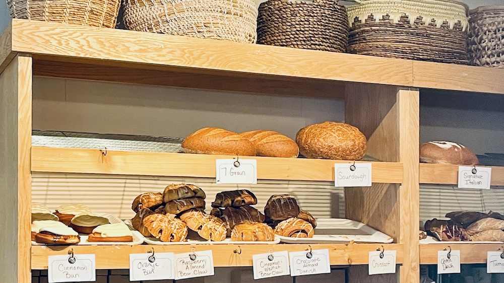 The shelves at bread basket bakery in saratoga are filled in the morning with pastries, croissants and fresh loaves of bread.