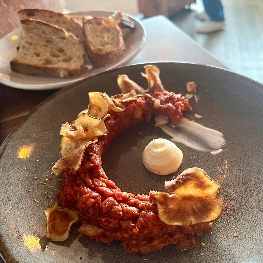 Steak tartare at hamlet & ghost in saratoga springs comes with good bread and homemade potato chips.