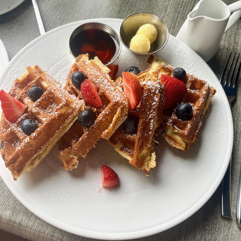 The buckwheat waffle at morrissey's in saratoga comes with fresh summer fruit, butter and maple syrup.